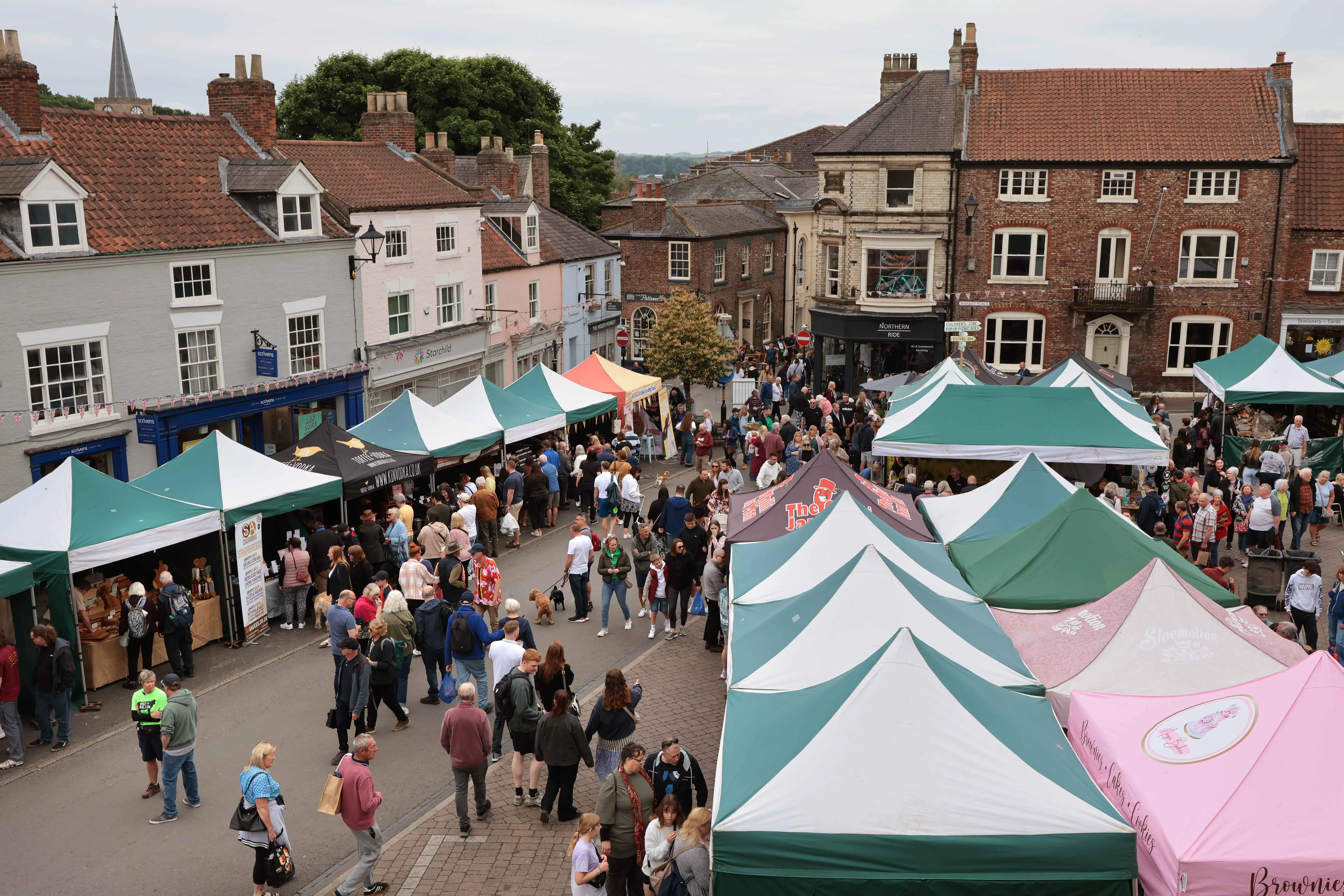 aerial view over the festival market with brightly coloured gazebos